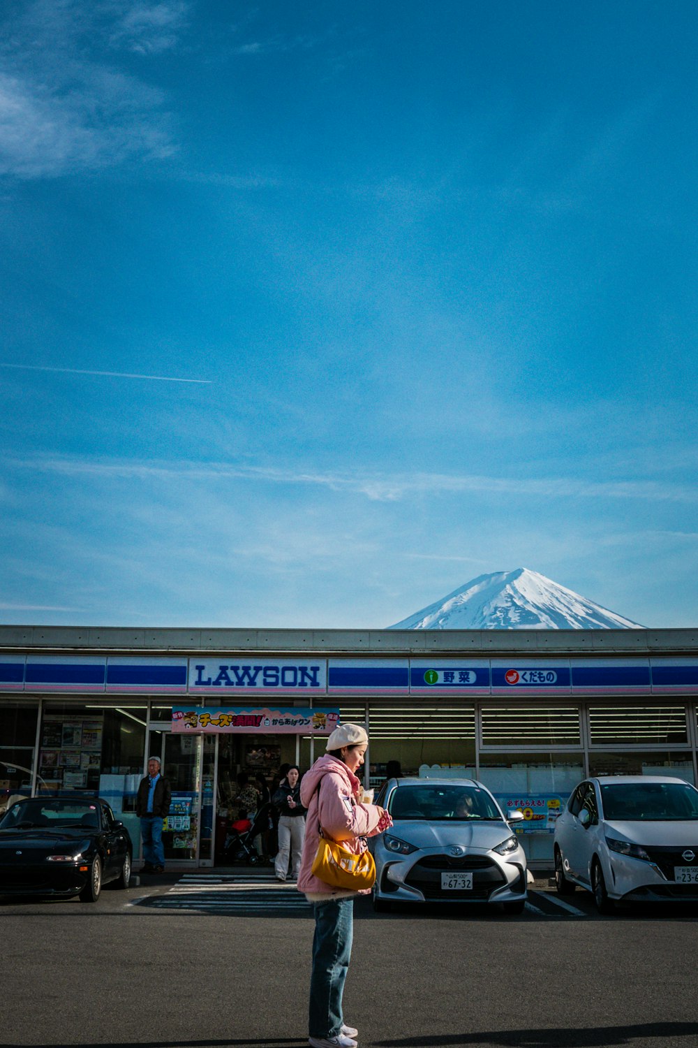 a woman standing in front of a car dealership