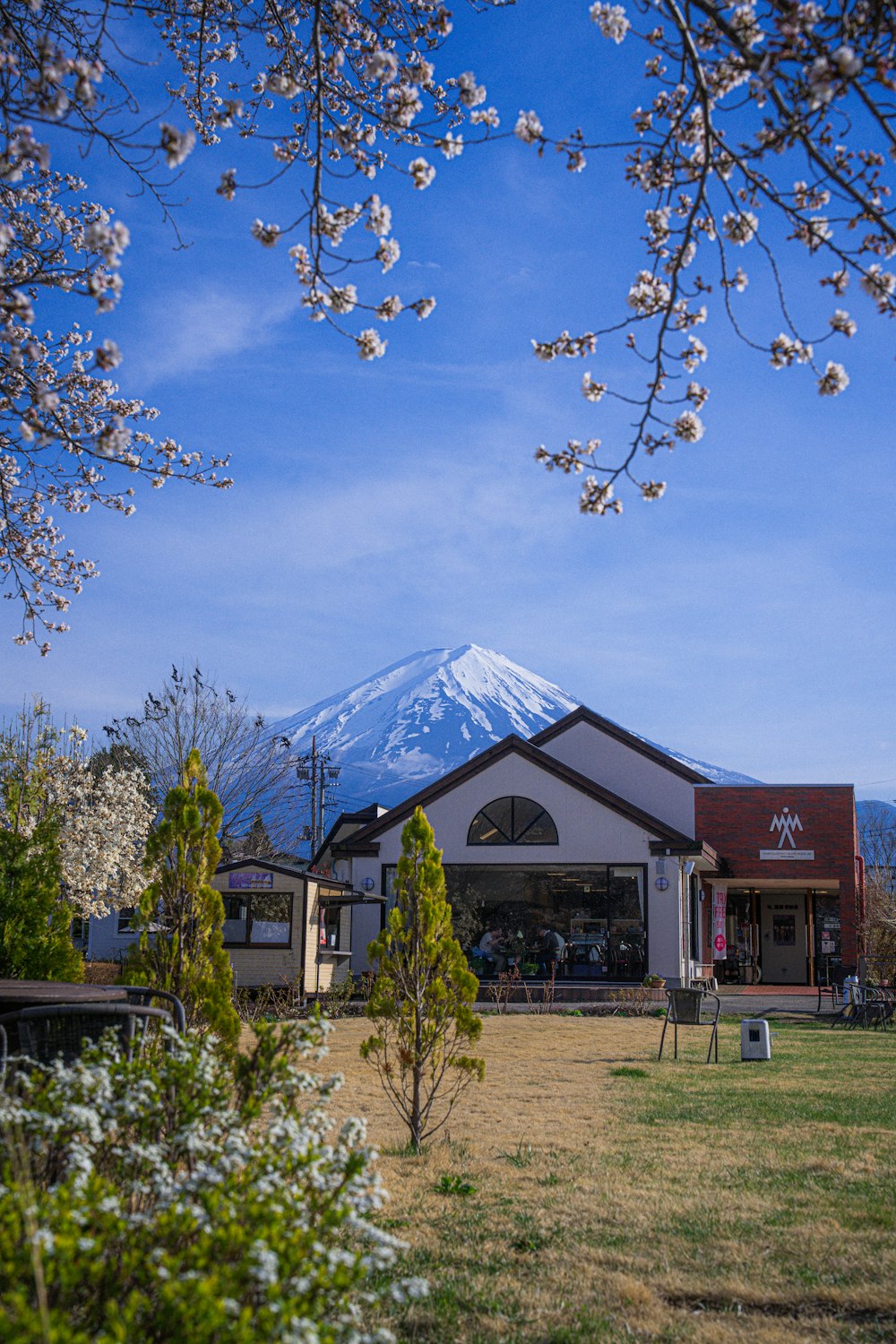 a building with a snow covered mountain in the background