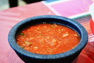 a bowl of soup sitting on top of a table
