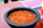 a bowl of soup sitting on top of a table
