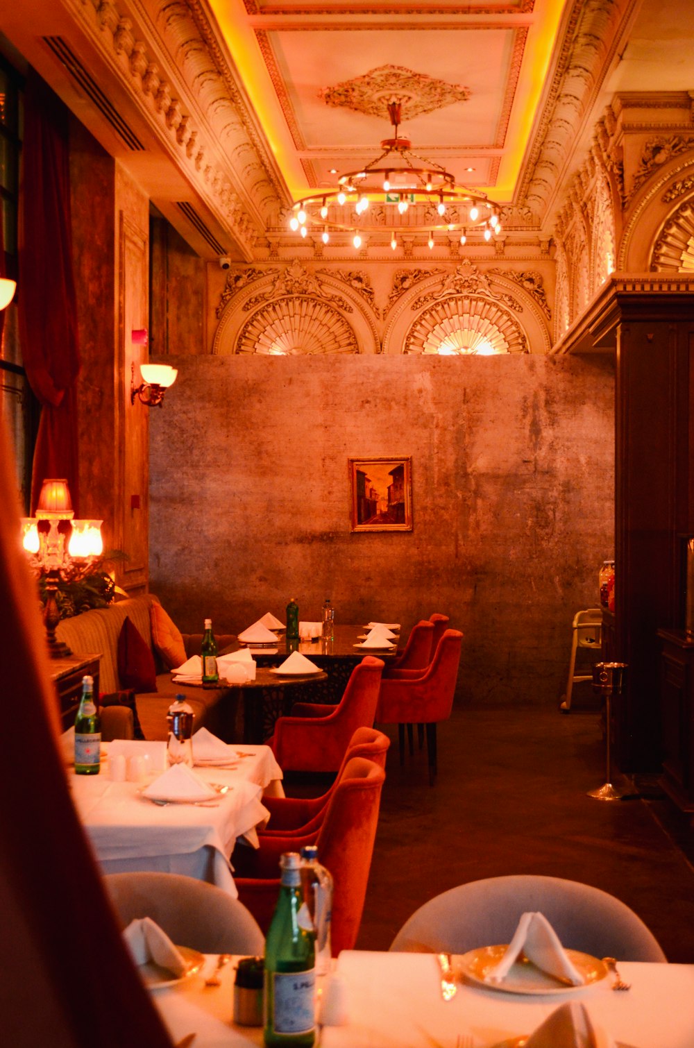 a dimly lit restaurant with tables and chairs