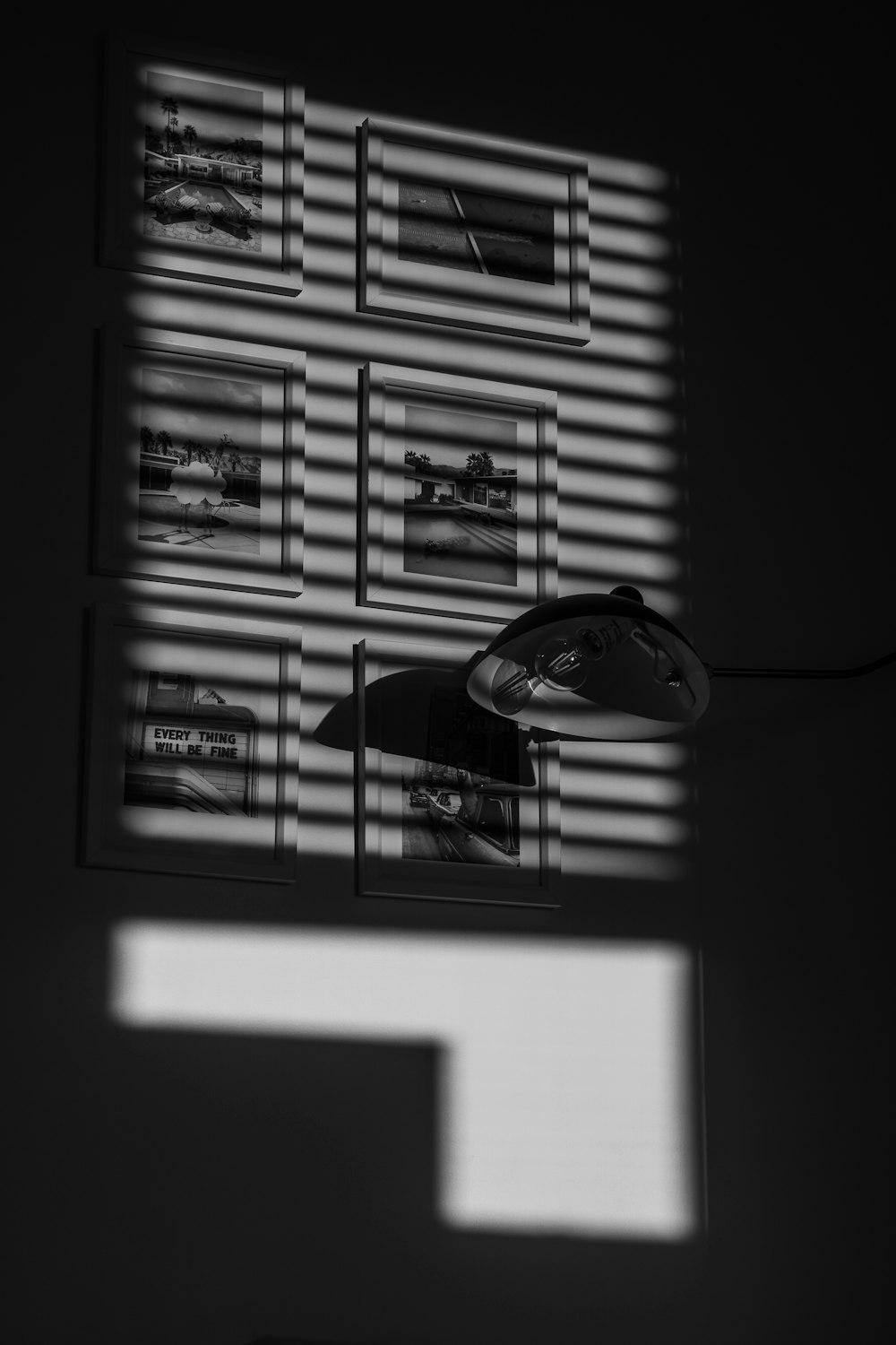 a black and white photo of a window with blinds