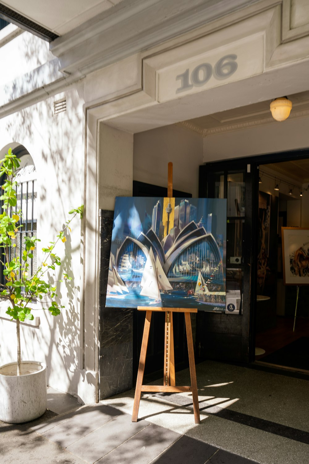 a painting of a cityscape in front of a building