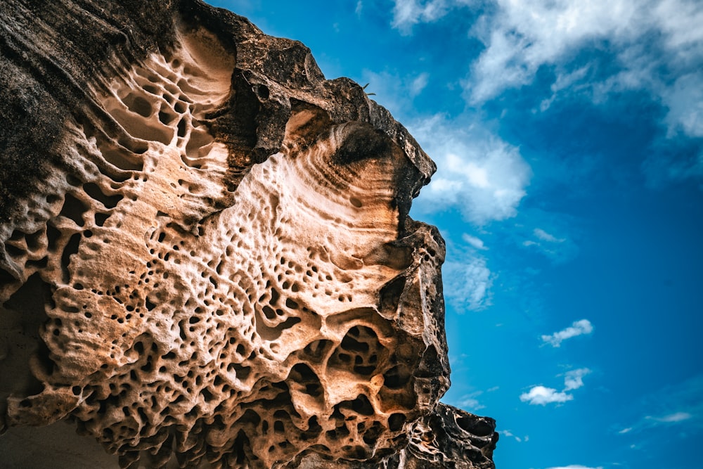 a rock formation with a blue sky in the background