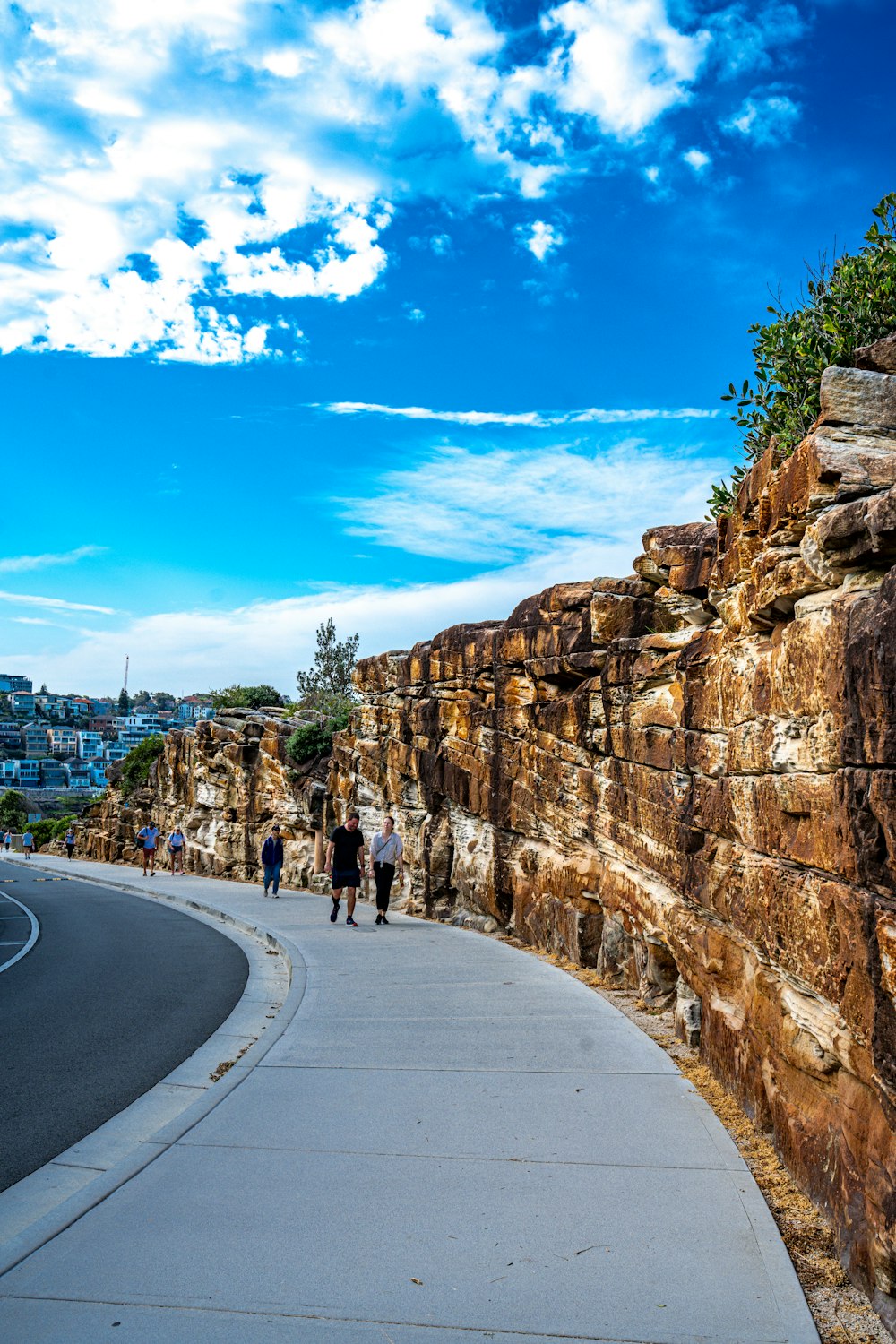 a couple of people that are walking on a sidewalk