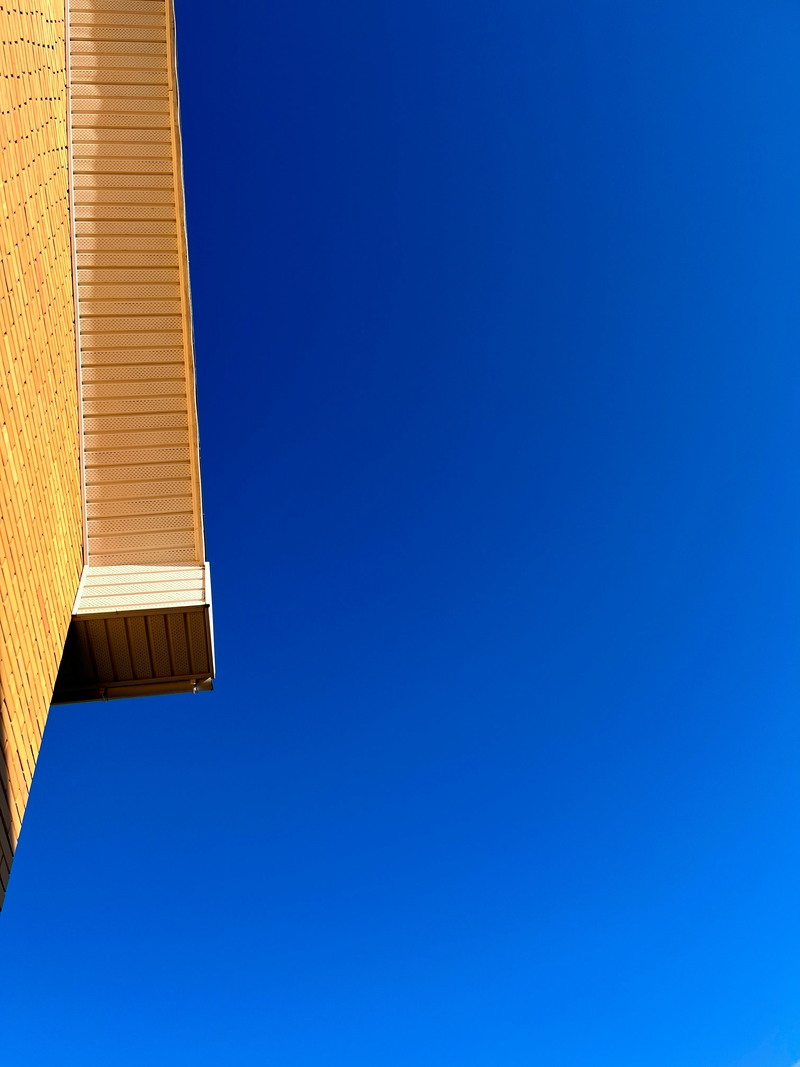 a tall building with a blue sky in the background