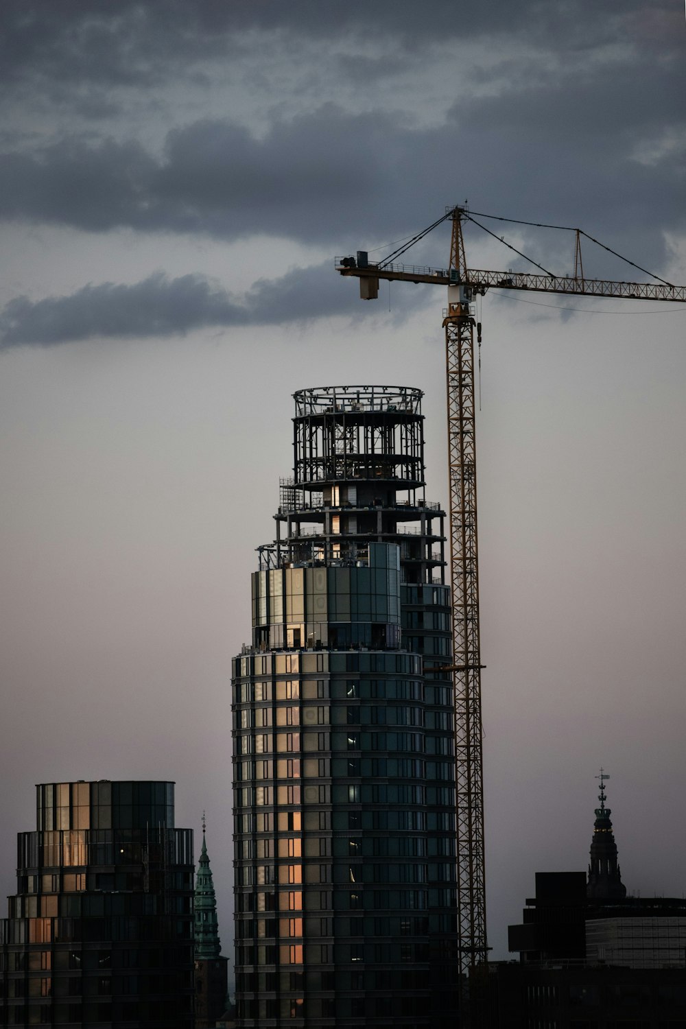 a tall building with a crane on top of it