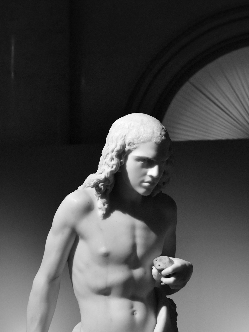 a black and white photo of a statue of a man
