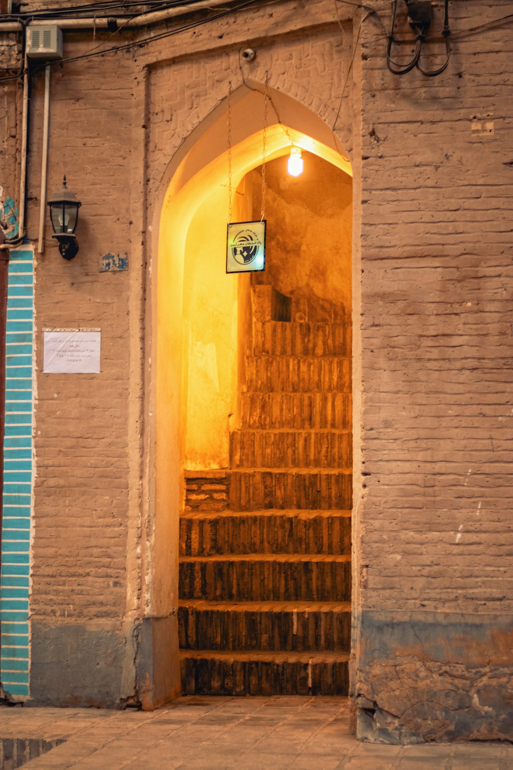 a brick building with a doorway and a set of stairs