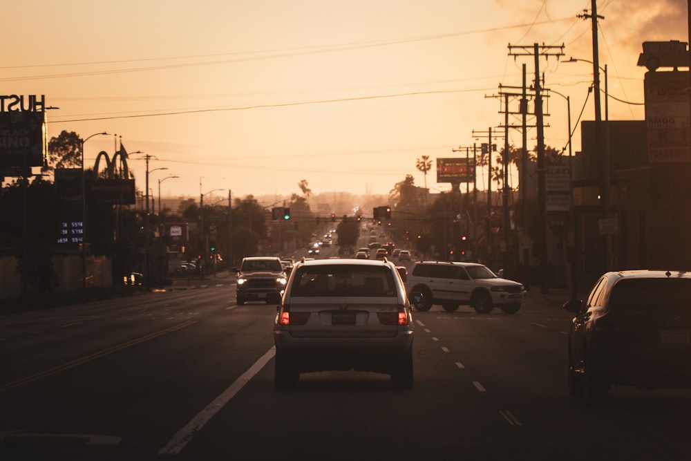 a city street filled with lots of traffic at sunset