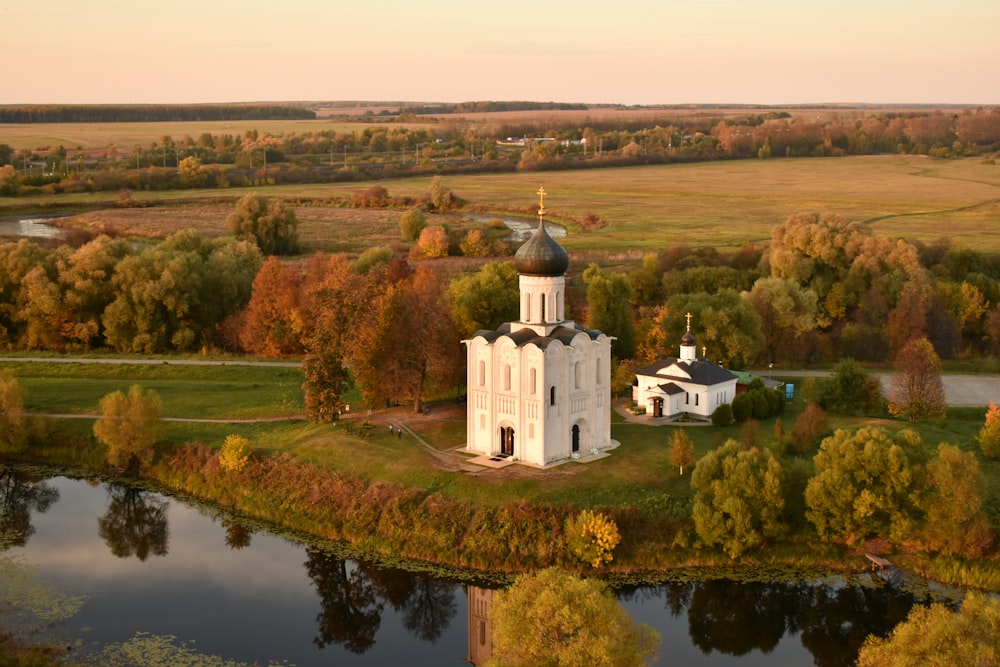 an aerial view of a church surrounded by trees