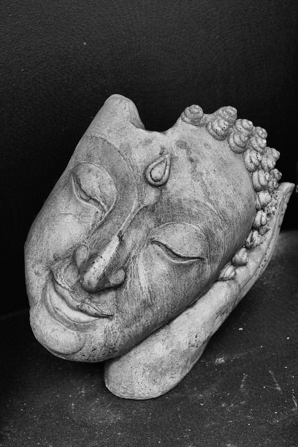 a black and white photo of a buddha statue