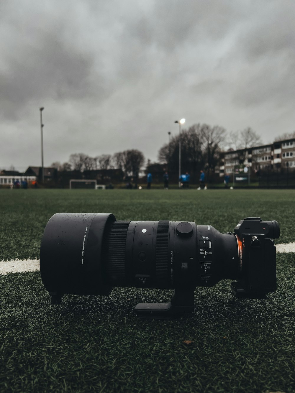 a camera lens sitting on top of a green field