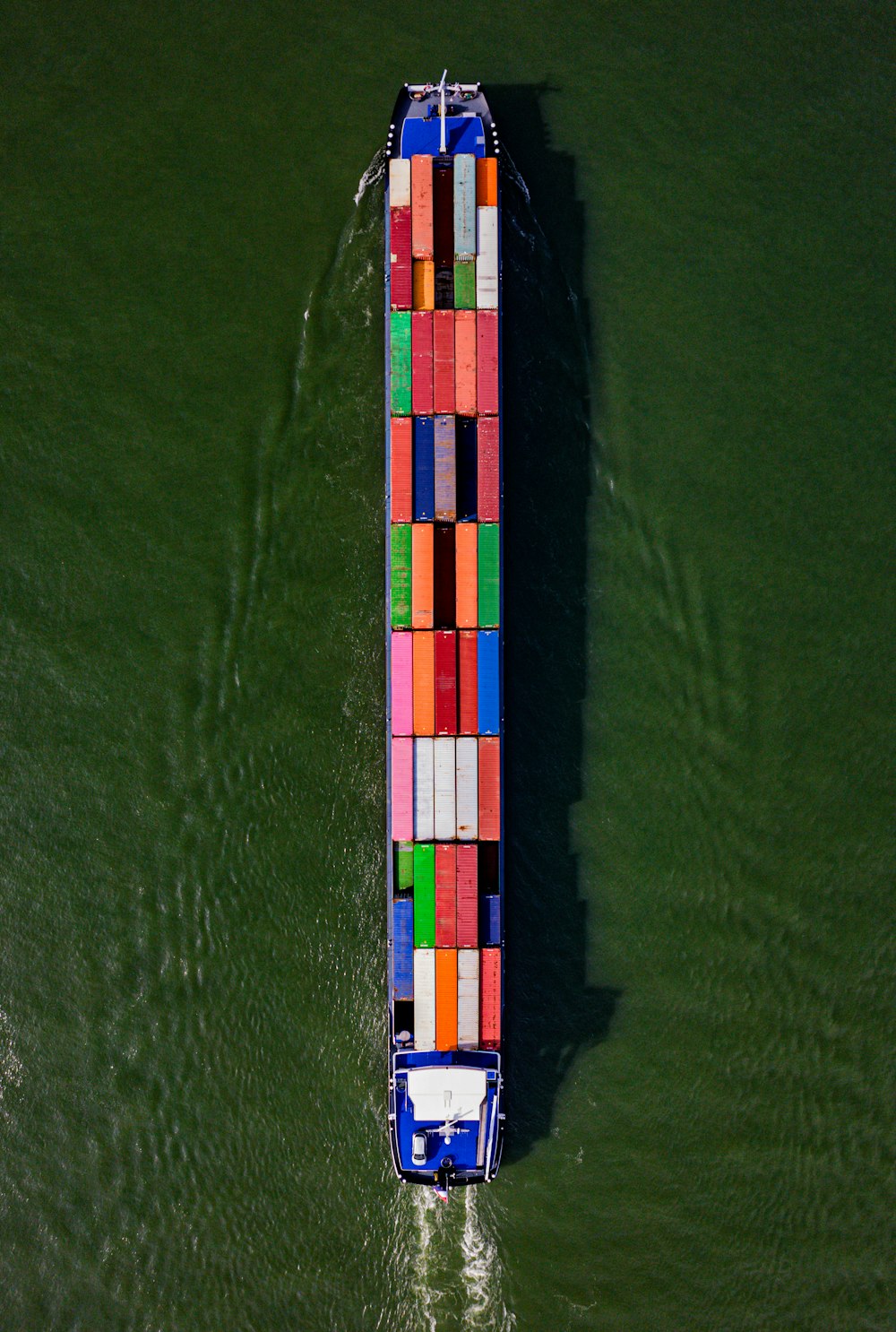 a large boat with a lot of colorful containers on it