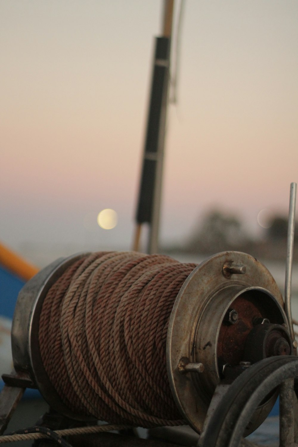 a spool of rope sitting on top of a boat