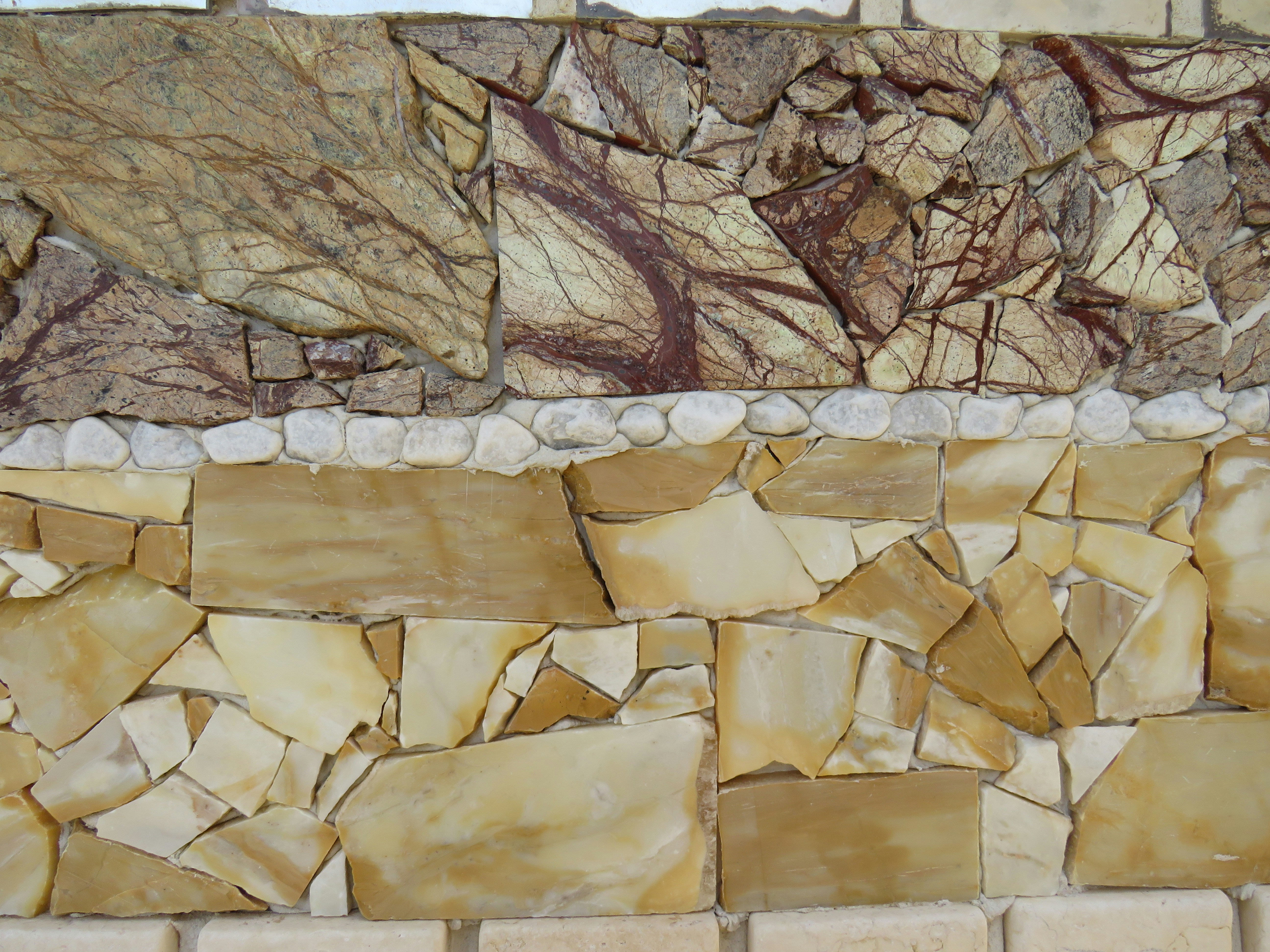 A close up of a wall made of rocks photo – Free Background Image on ...