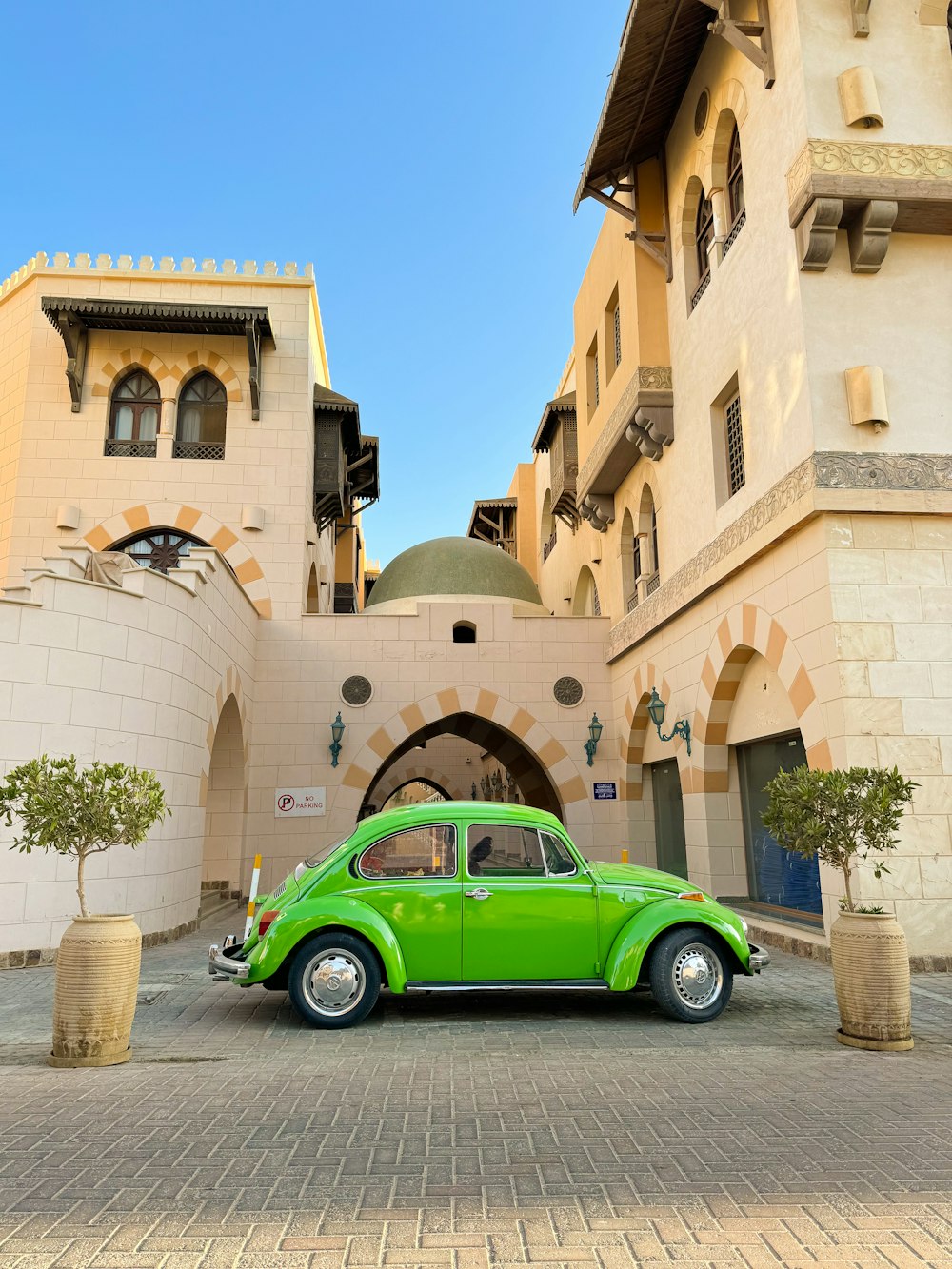 a green car parked in front of a building