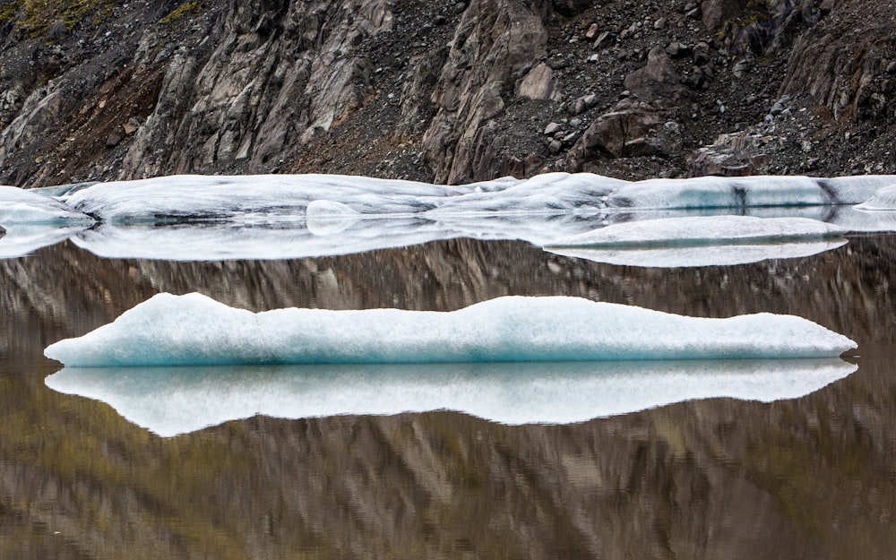 a large iceberg floating on top of a body of water