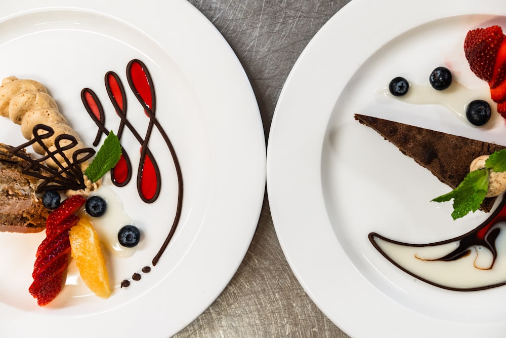 two white plates topped with different types of desserts