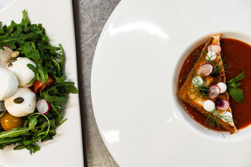 a white plate topped with food next to a salad