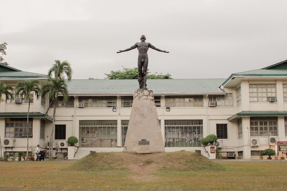 a statue of a man standing in front of a building