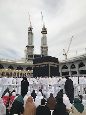 a group of people sitting in front of a large building
