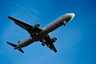 a large jetliner flying through a blue sky