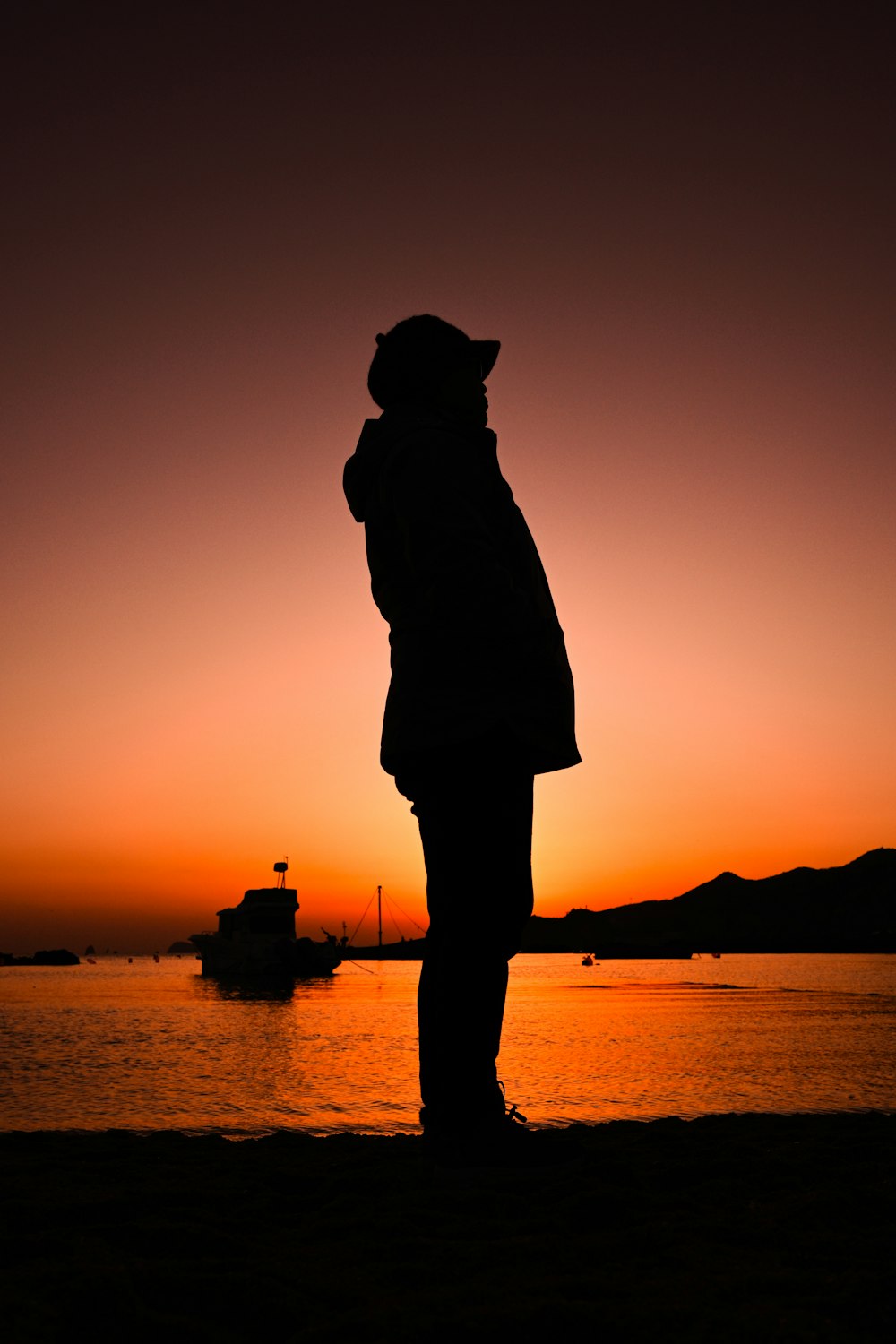 a person standing in front of a body of water