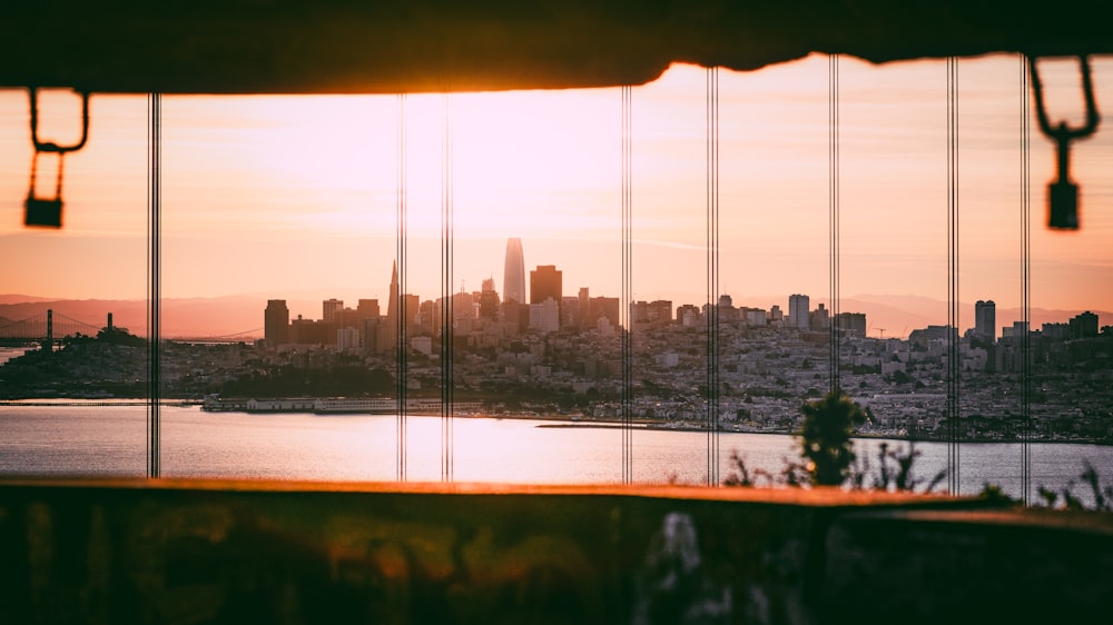 a view of a city and a body of water at sunset