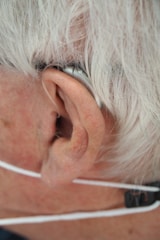 a close up of a person wearing a pair of ear phones