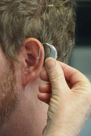 a man wearing a pair of ear piercings