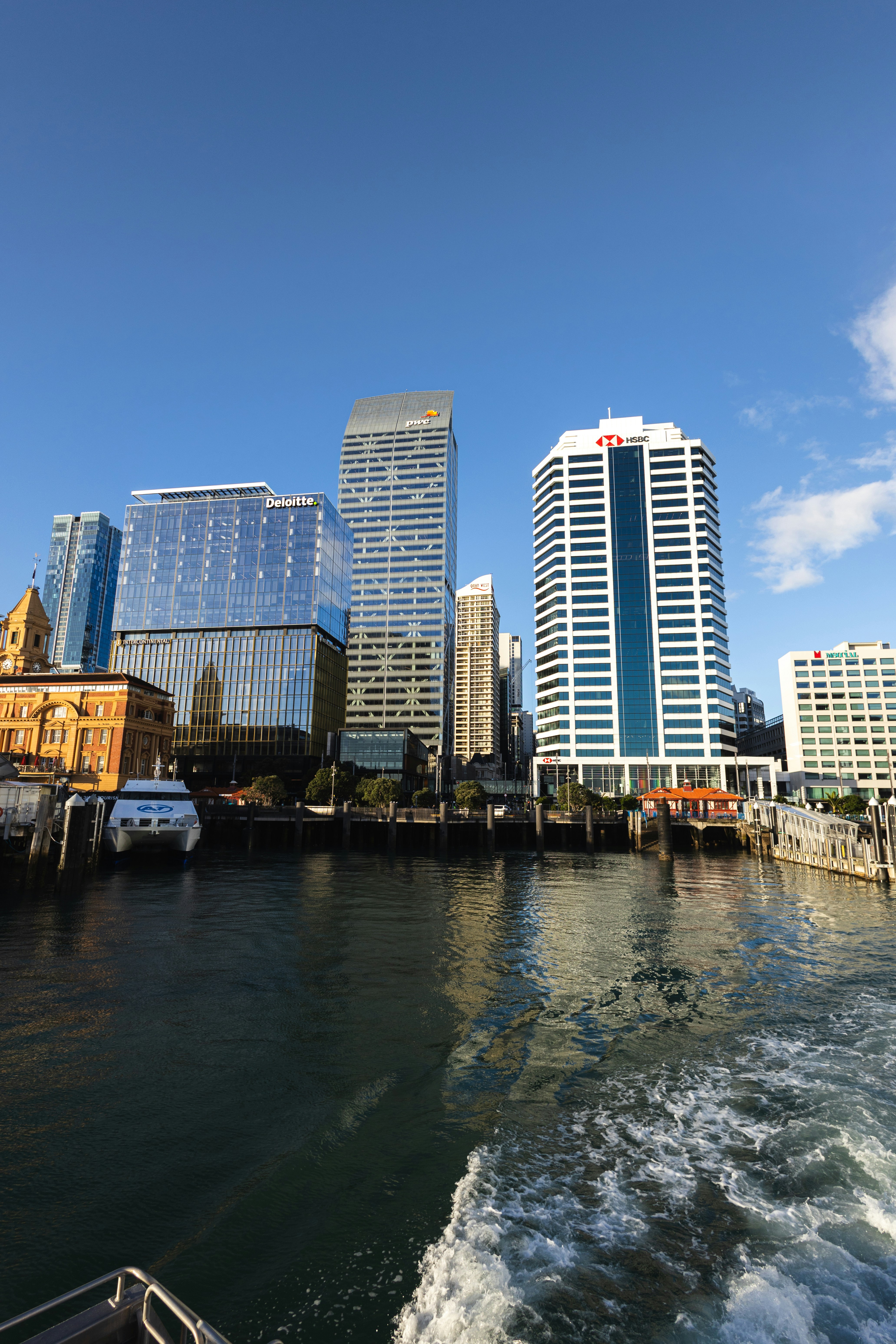 a boat traveling down a river next to tall buildings