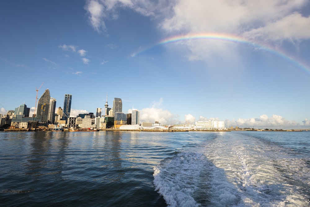 a view of a city with a rainbow in the sky