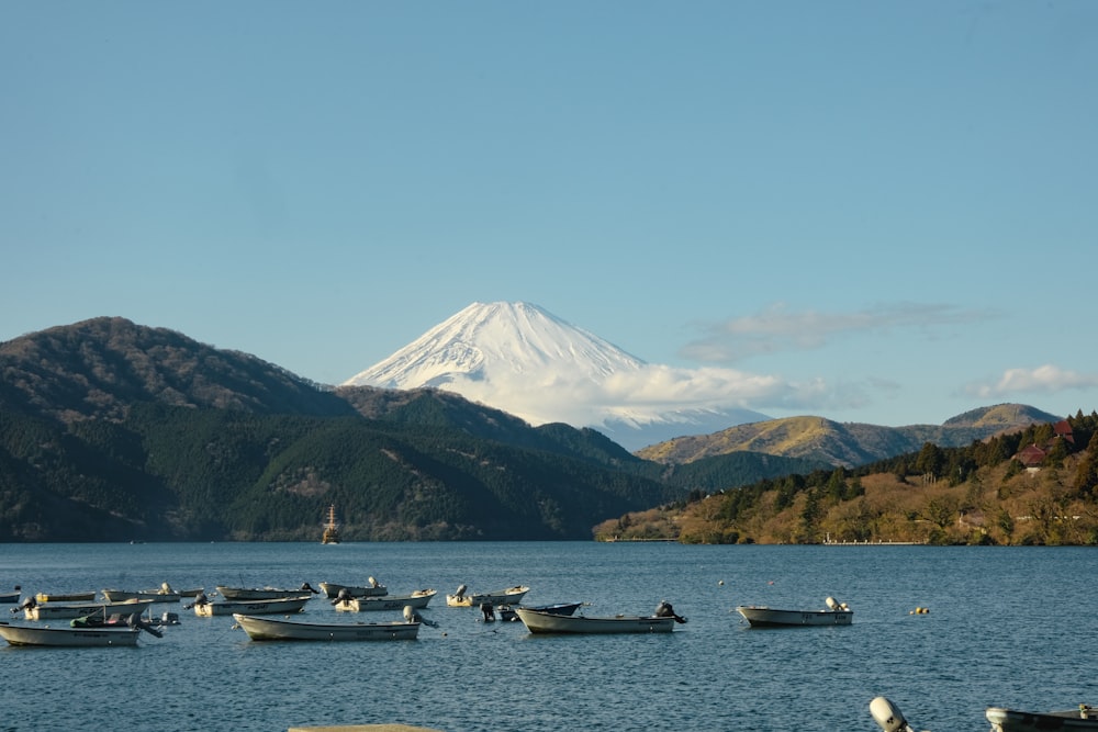 a group of boats floating on top of a lake