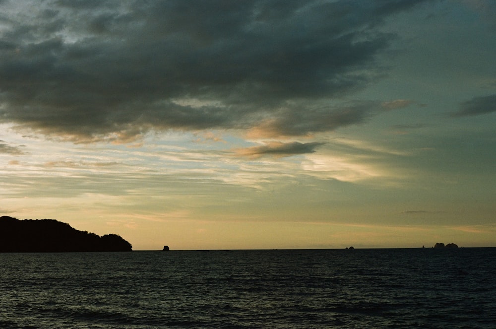 a large body of water under a cloudy sky