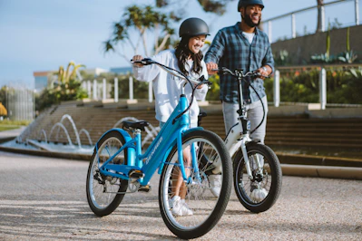 a man and a little girl are riding bikes
