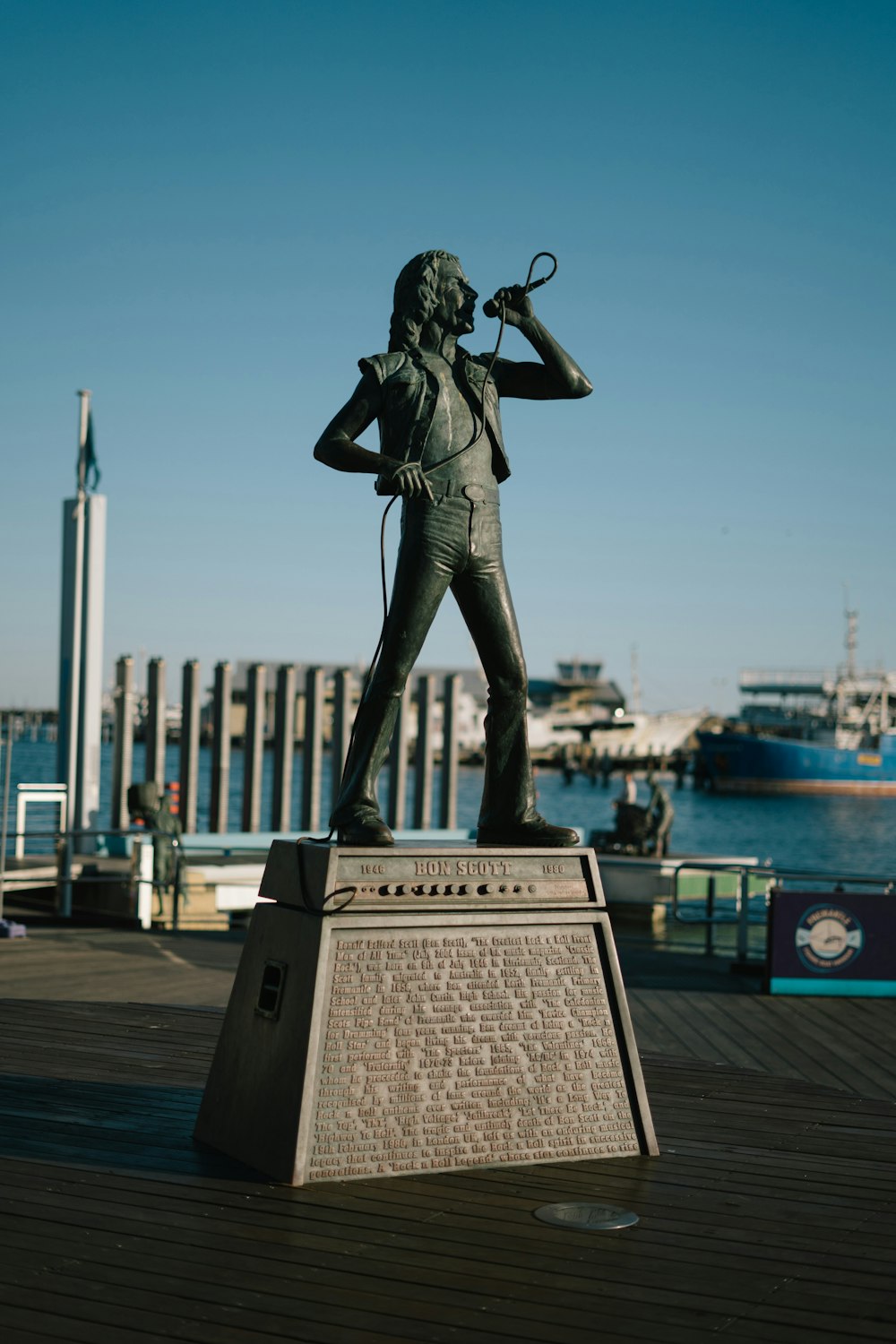 a statue of a man holding a magnifying glass