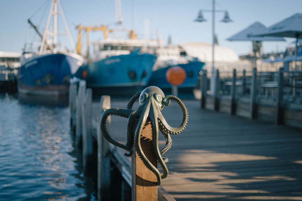 a wooden dock with two boats in the background