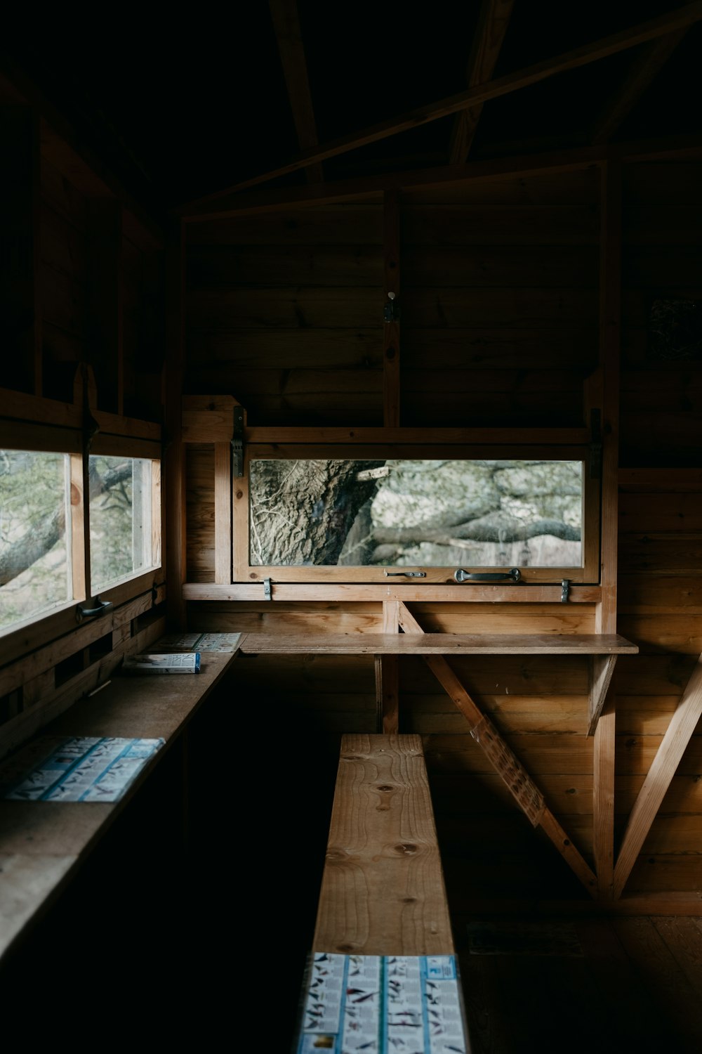 a room with a bench and windows in it