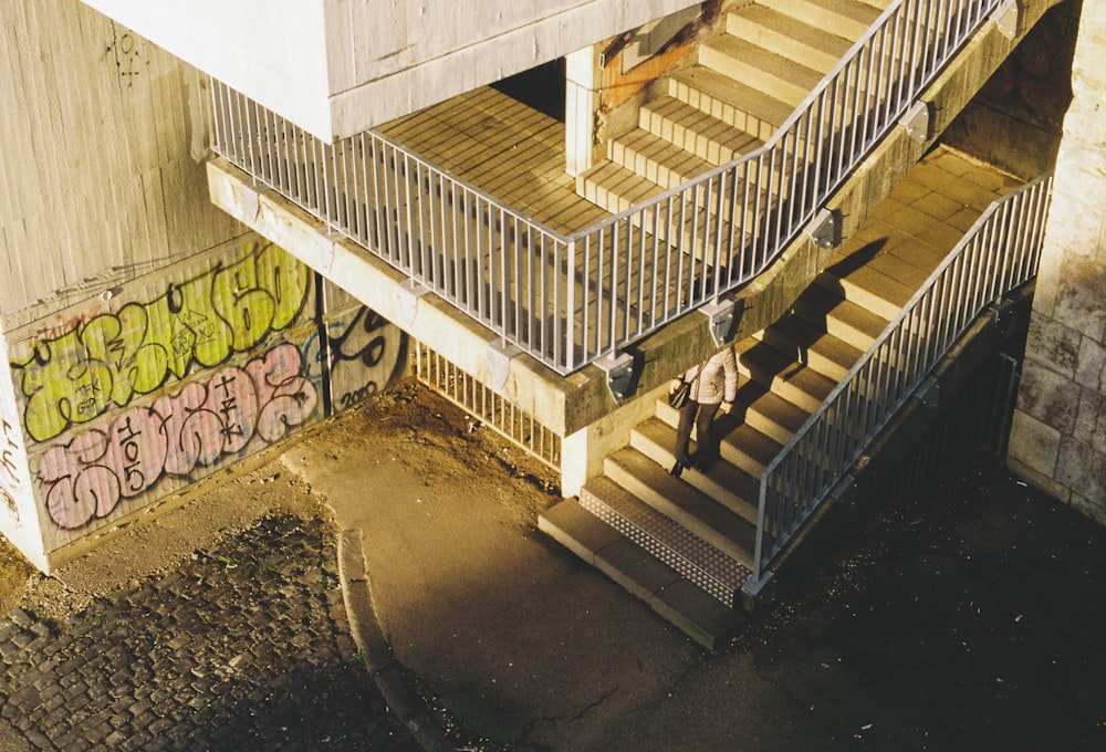 a couple of people that are standing on some stairs