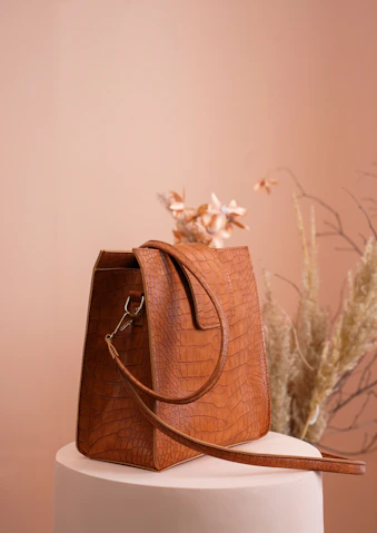 a brown purse sitting on top of a white cake