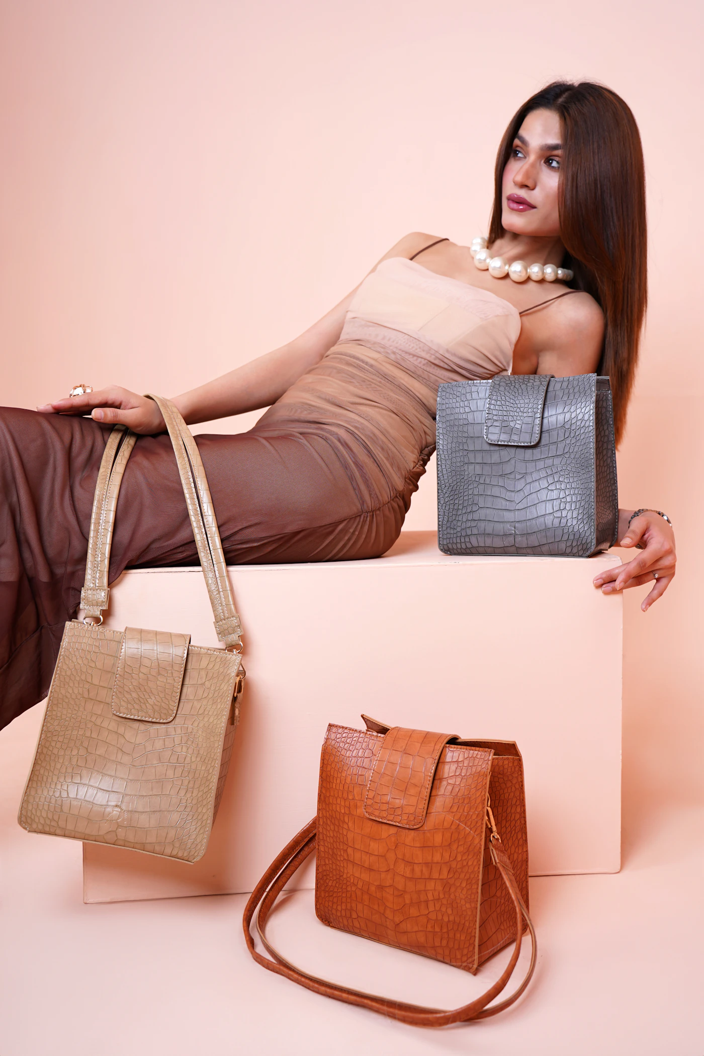 Woman presenting two handbags