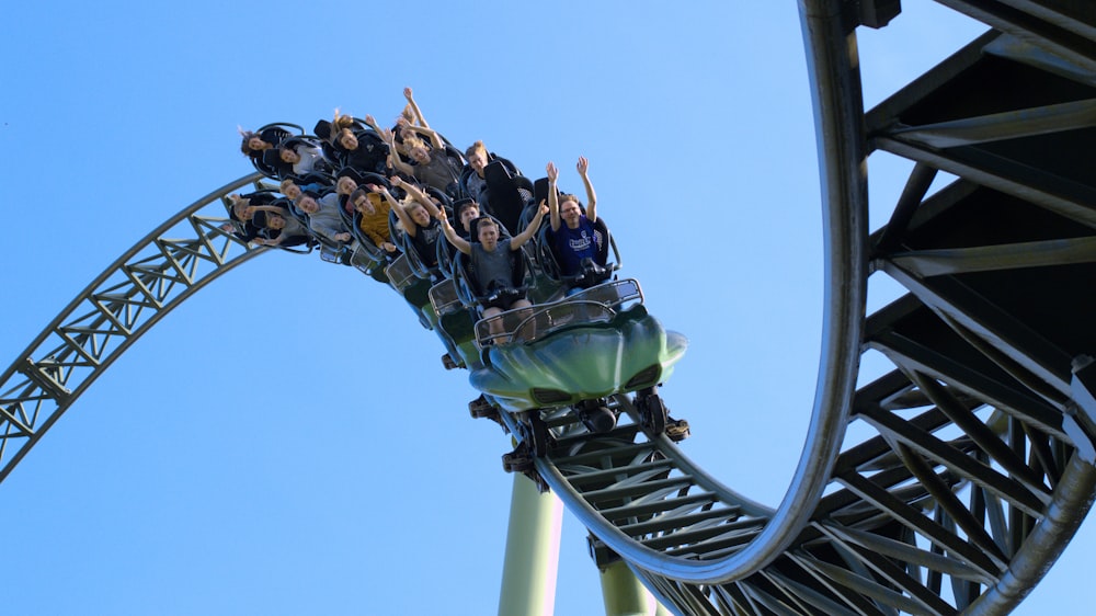 a group of people riding on top of a roller coaster