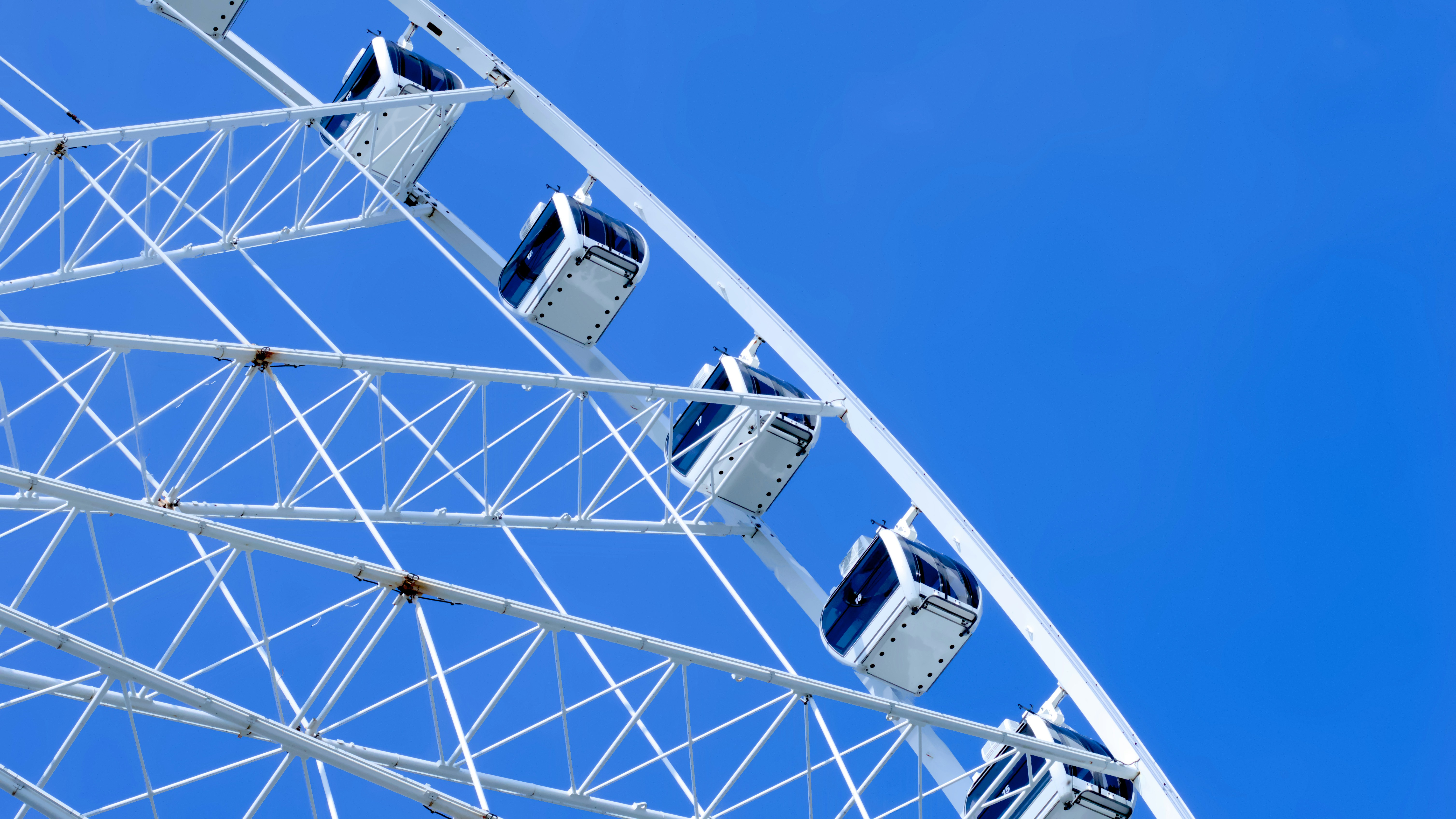 a ferris wheel with blue sky in the background