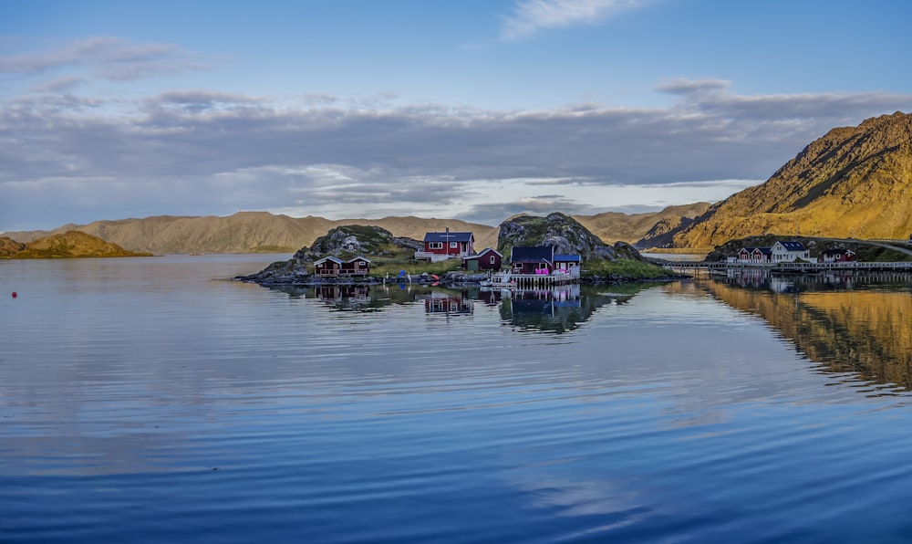 a body of water surrounded by mountains and houses