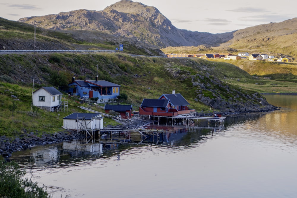 a body of water surrounded by mountains and houses