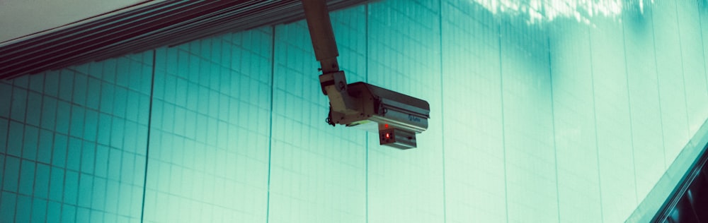 a security camera mounted to the side of a building