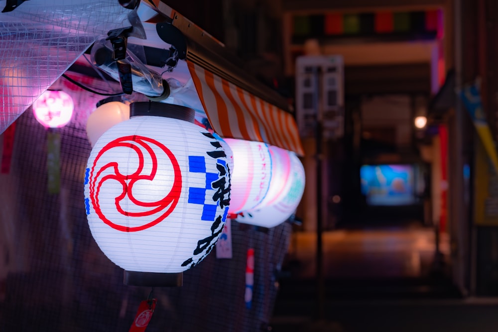 a white and red lantern hanging from a ceiling