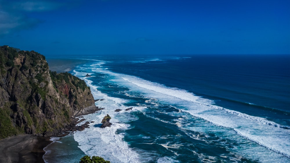 a view of the ocean from the top of a hill