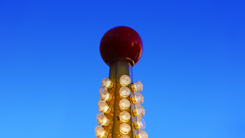 a street light with a red apple on top of it